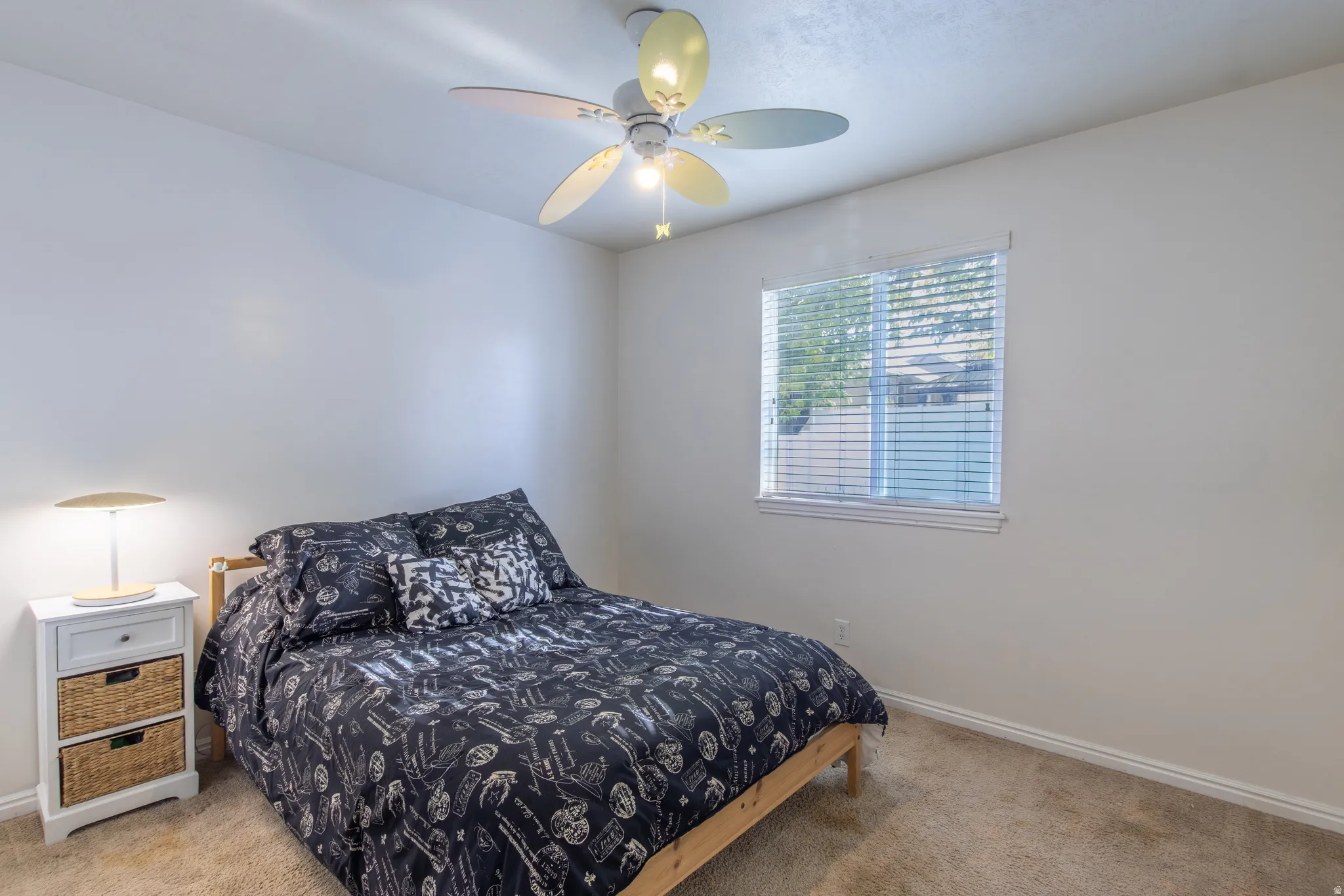 Carpeted bedroom featuring baseboards and a ceiling fan