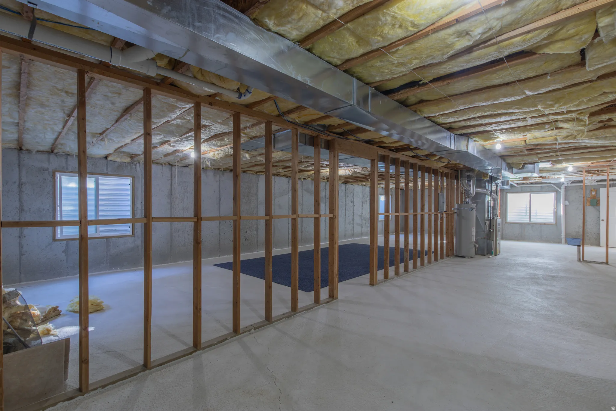 Basement featuring water heater and heating unit