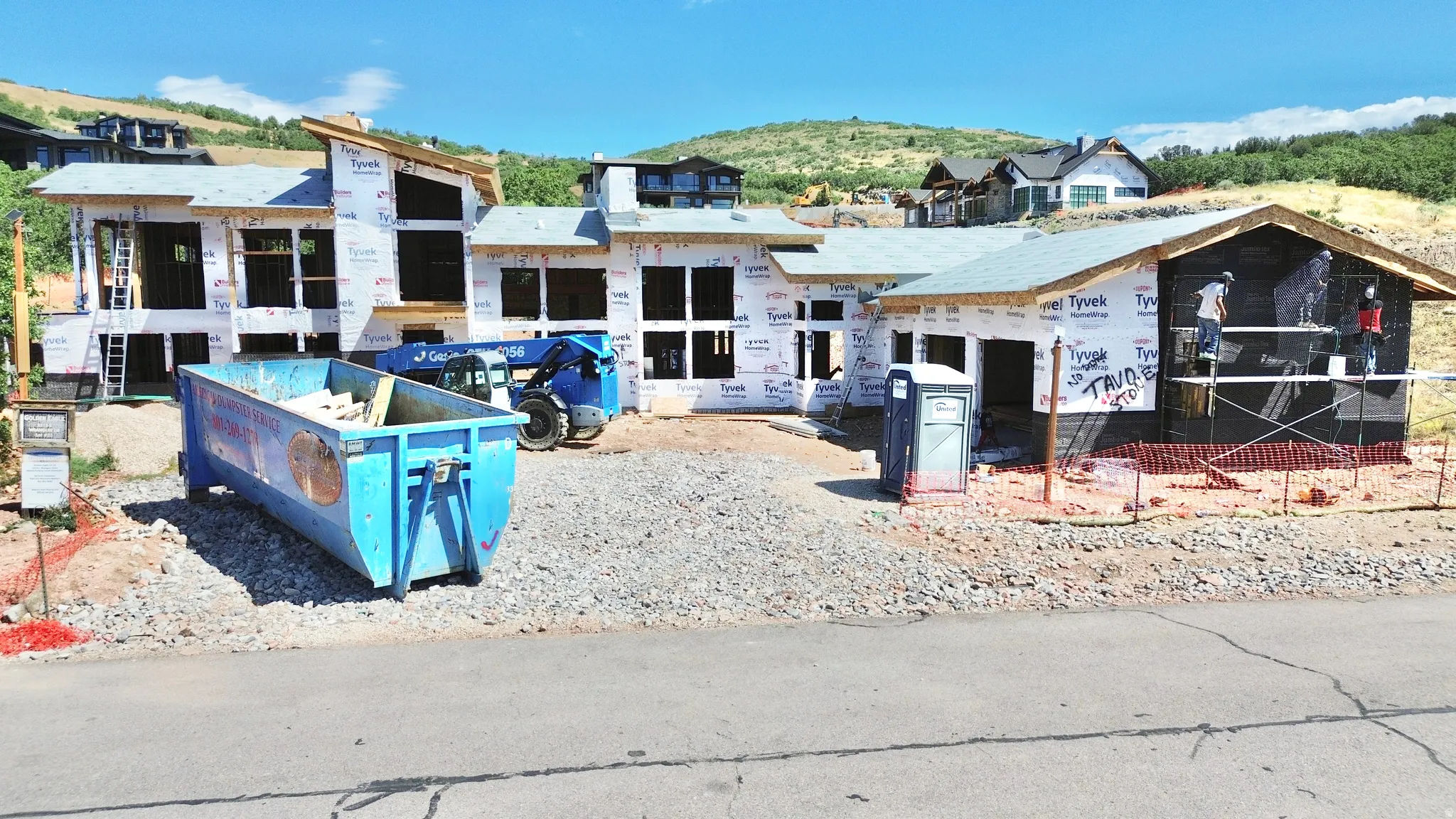 New construction opportunity featuring a modern architectural design, multiple large window openings, and a prominent hillside setting