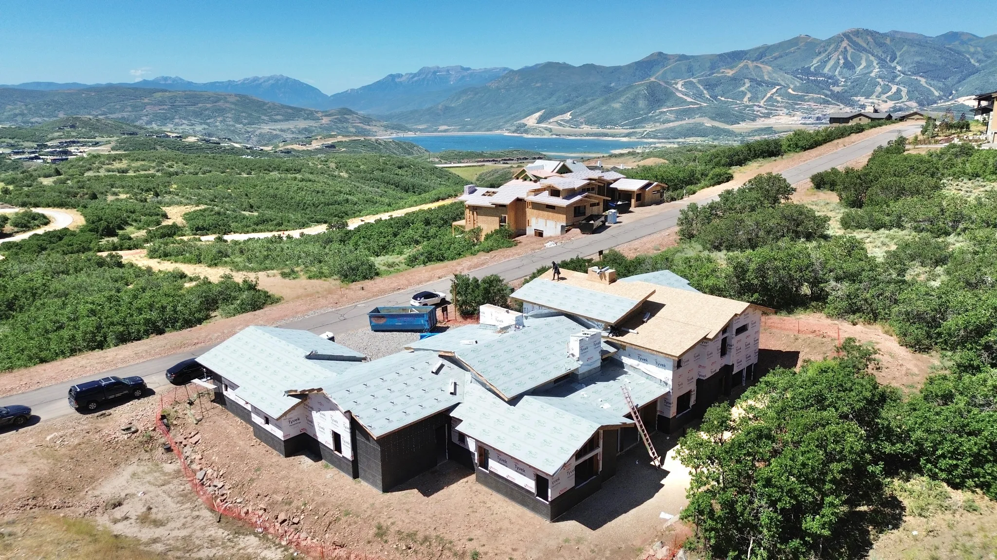 New construction property featuring multiple rooflines and a sloped lot