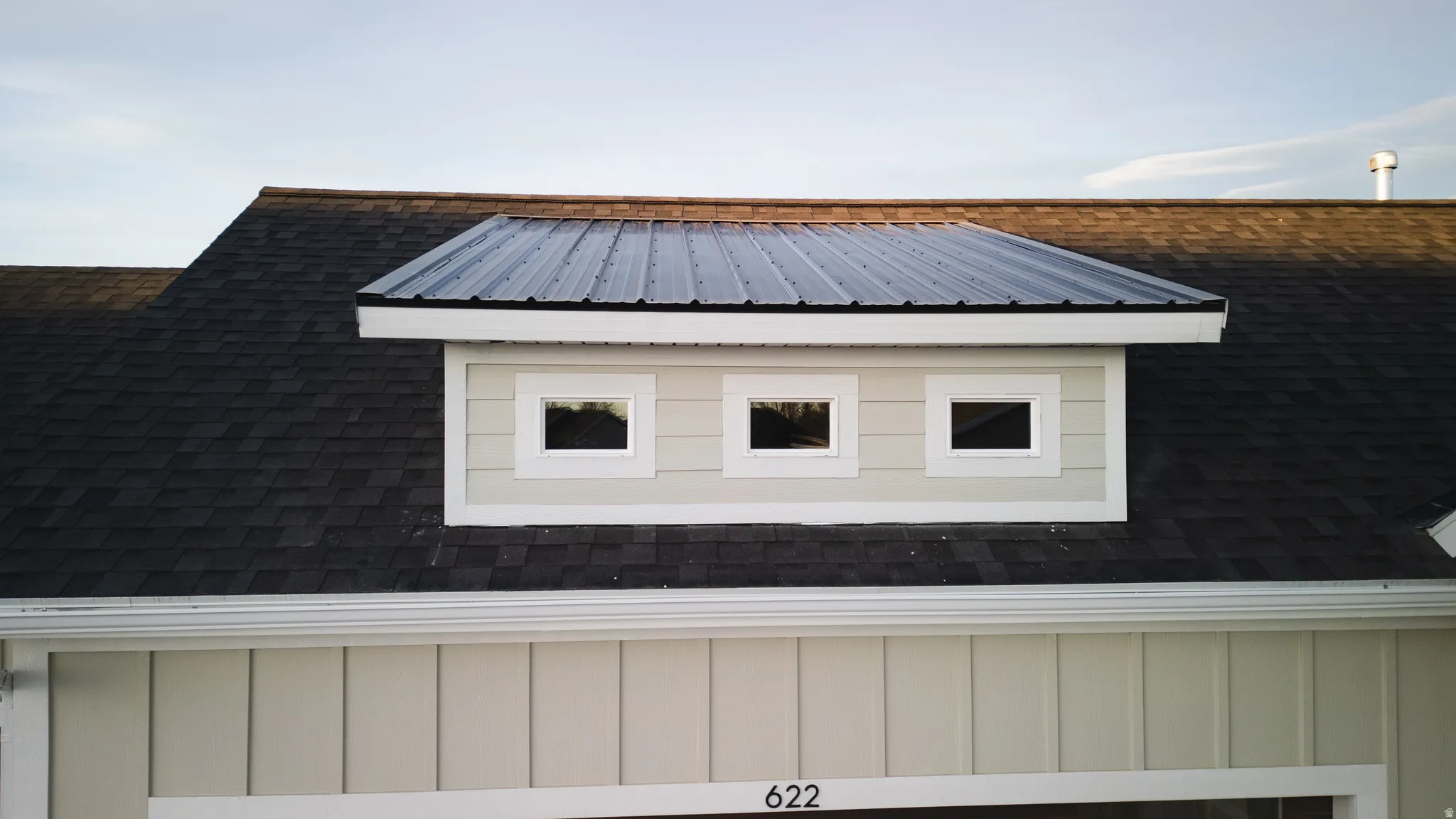 Exterior view of board and batten siding and roof with shingles