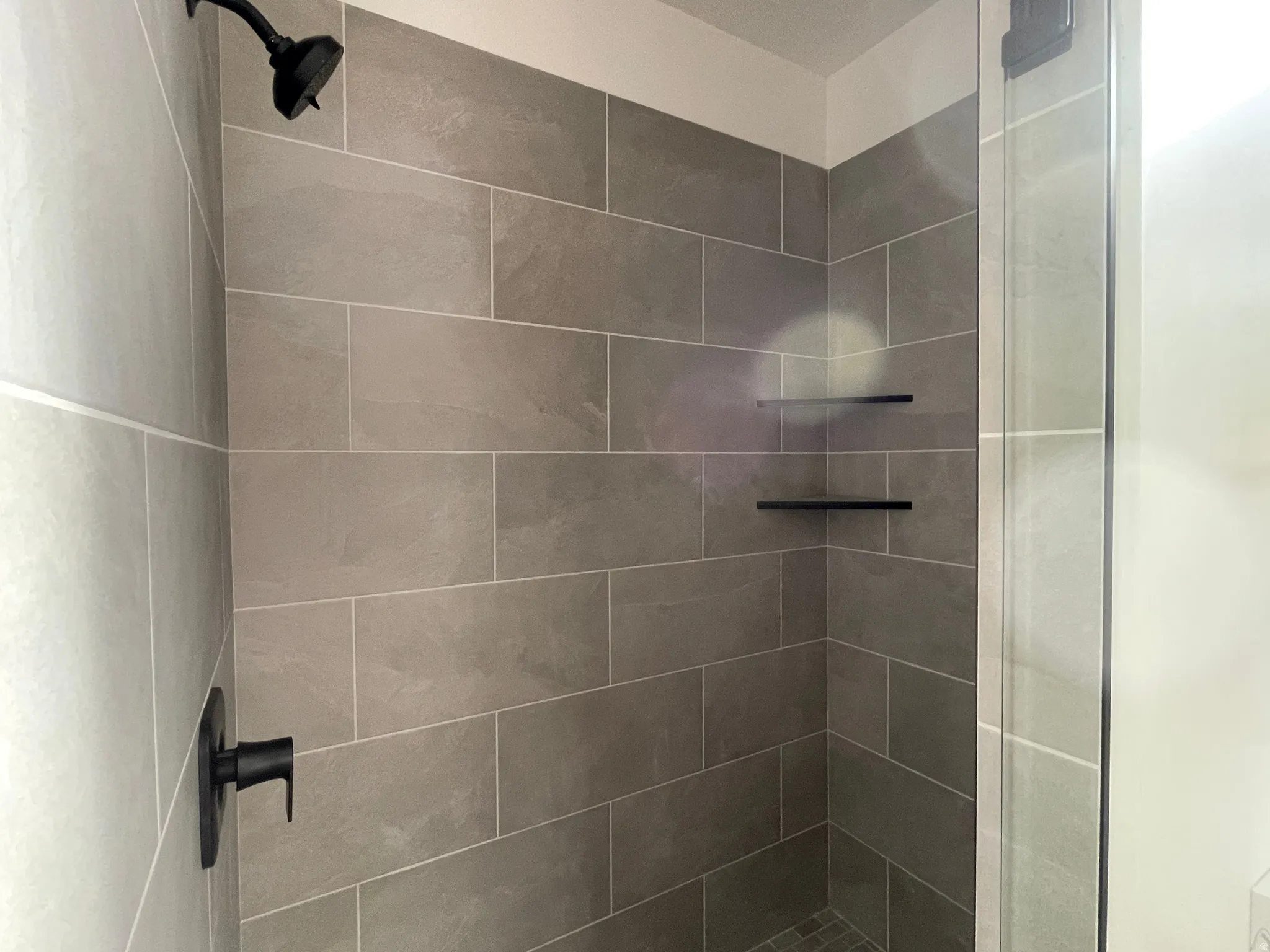 Full bath featuring a shower stall