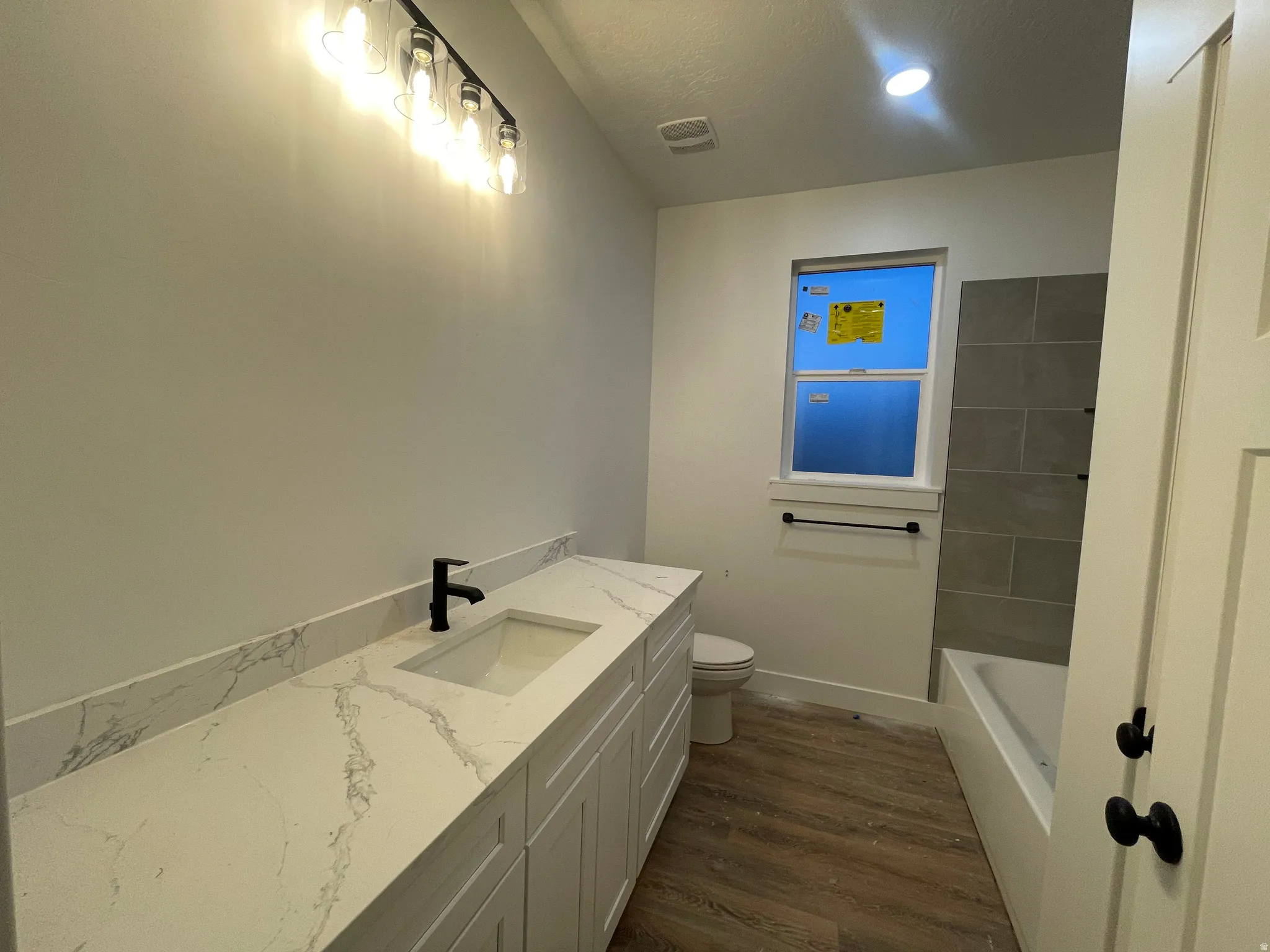 Bathroom with vanity and dark wood-type flooring