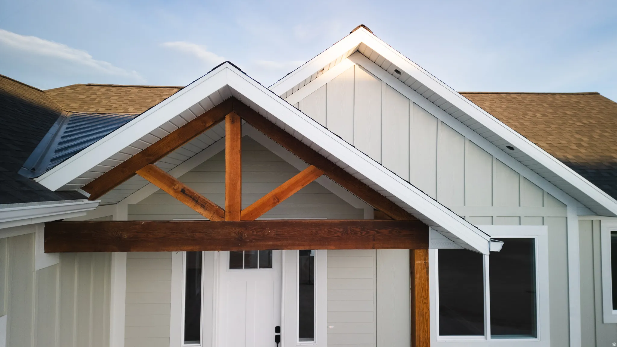 Exterior view of board and batten siding and a shingled roof