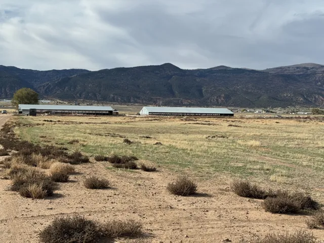 View of mountain backdrop featuring rural landscape