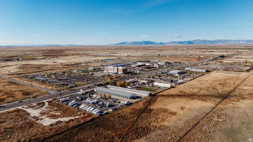 Bird's eye view of industrial structures and a mountain backdrop