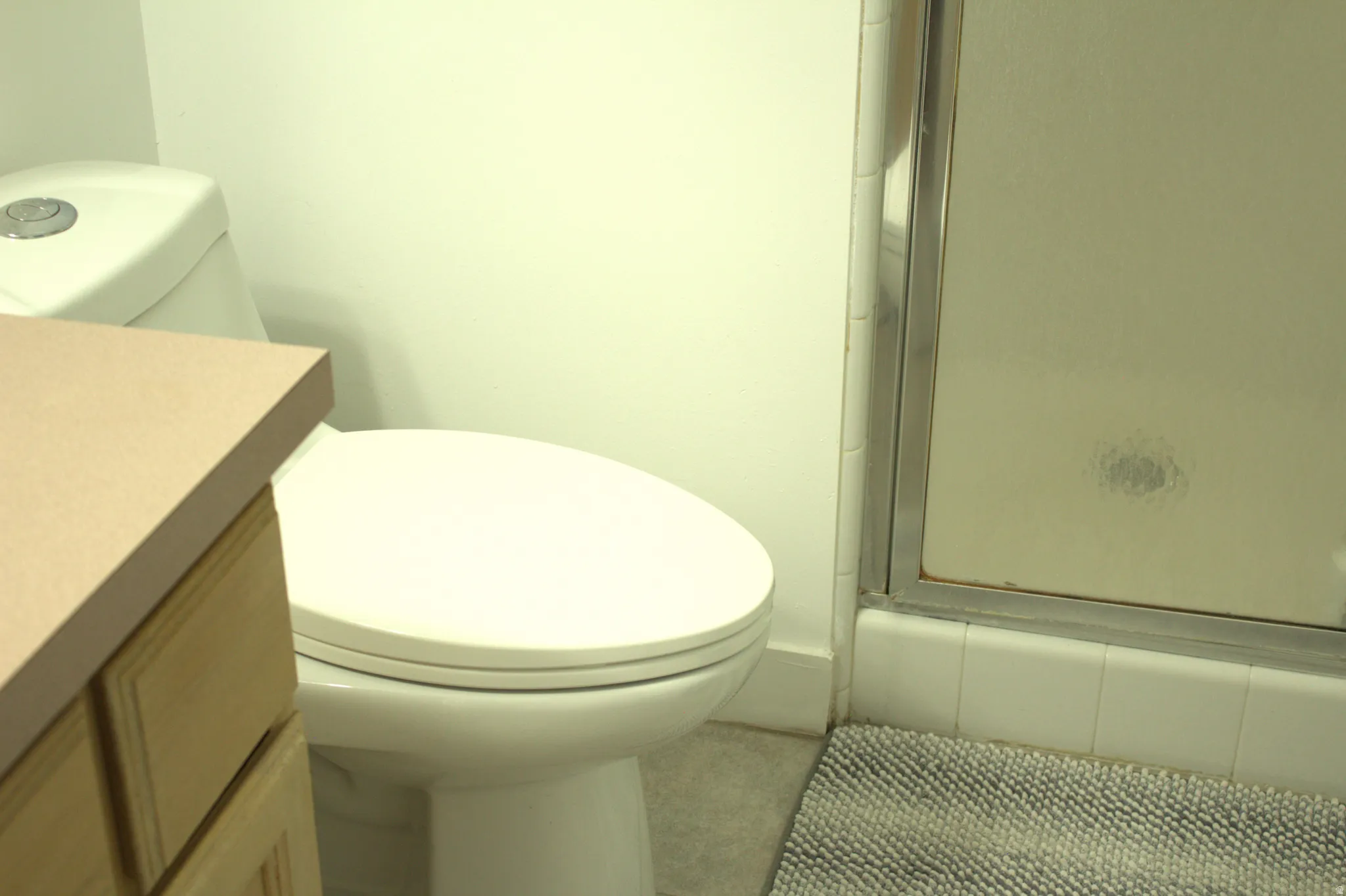 Full bathroom with vanity, a shower stall, and tile patterned flooring