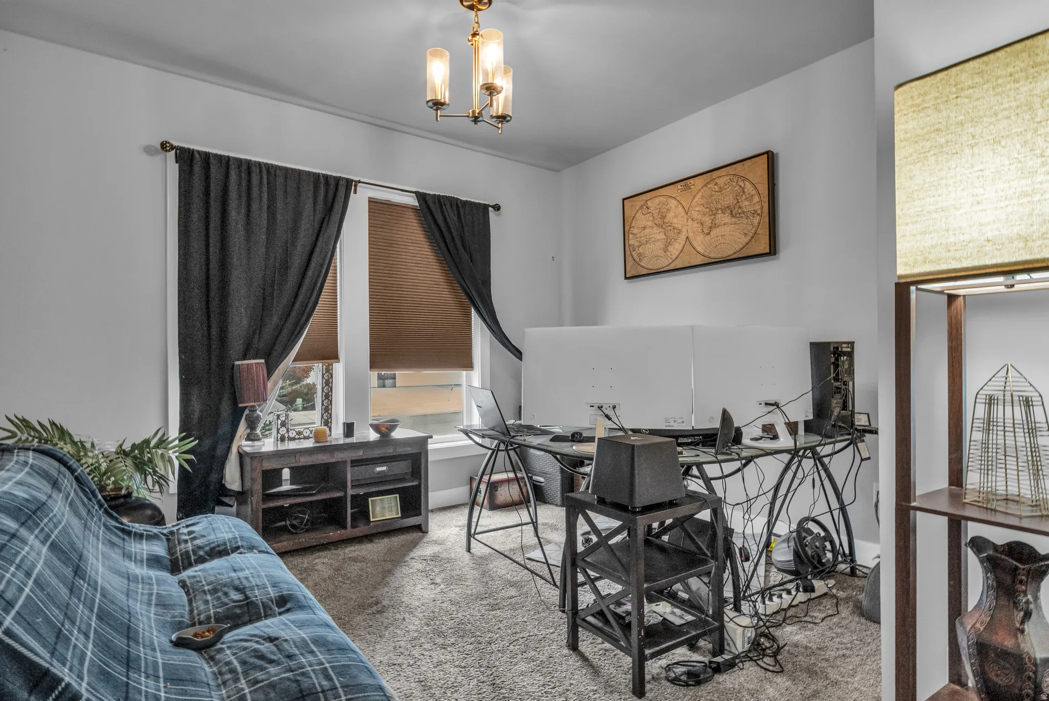 Home office with carpet flooring and a chandelier