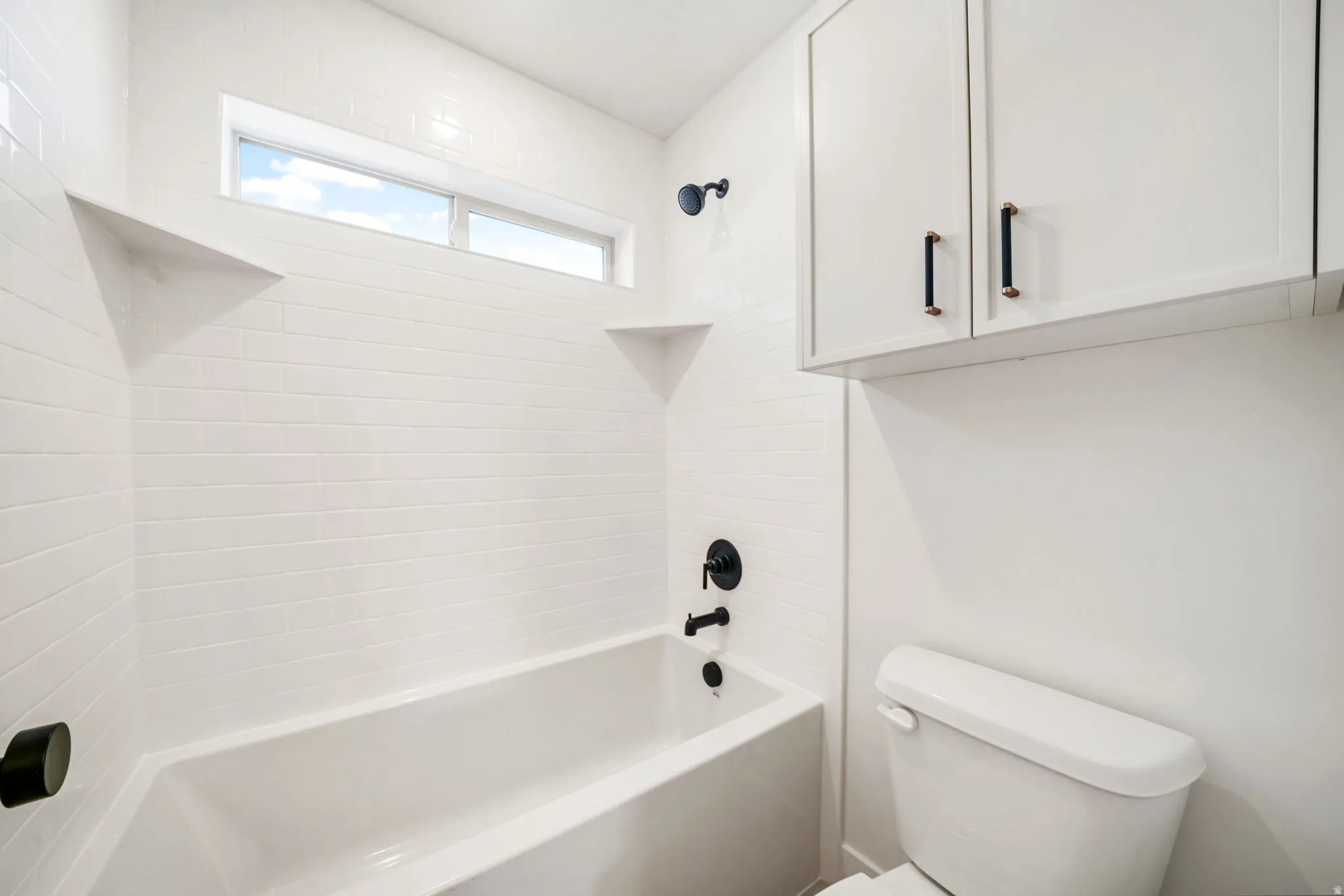 Full bath featuring shower / bath combination and toilet