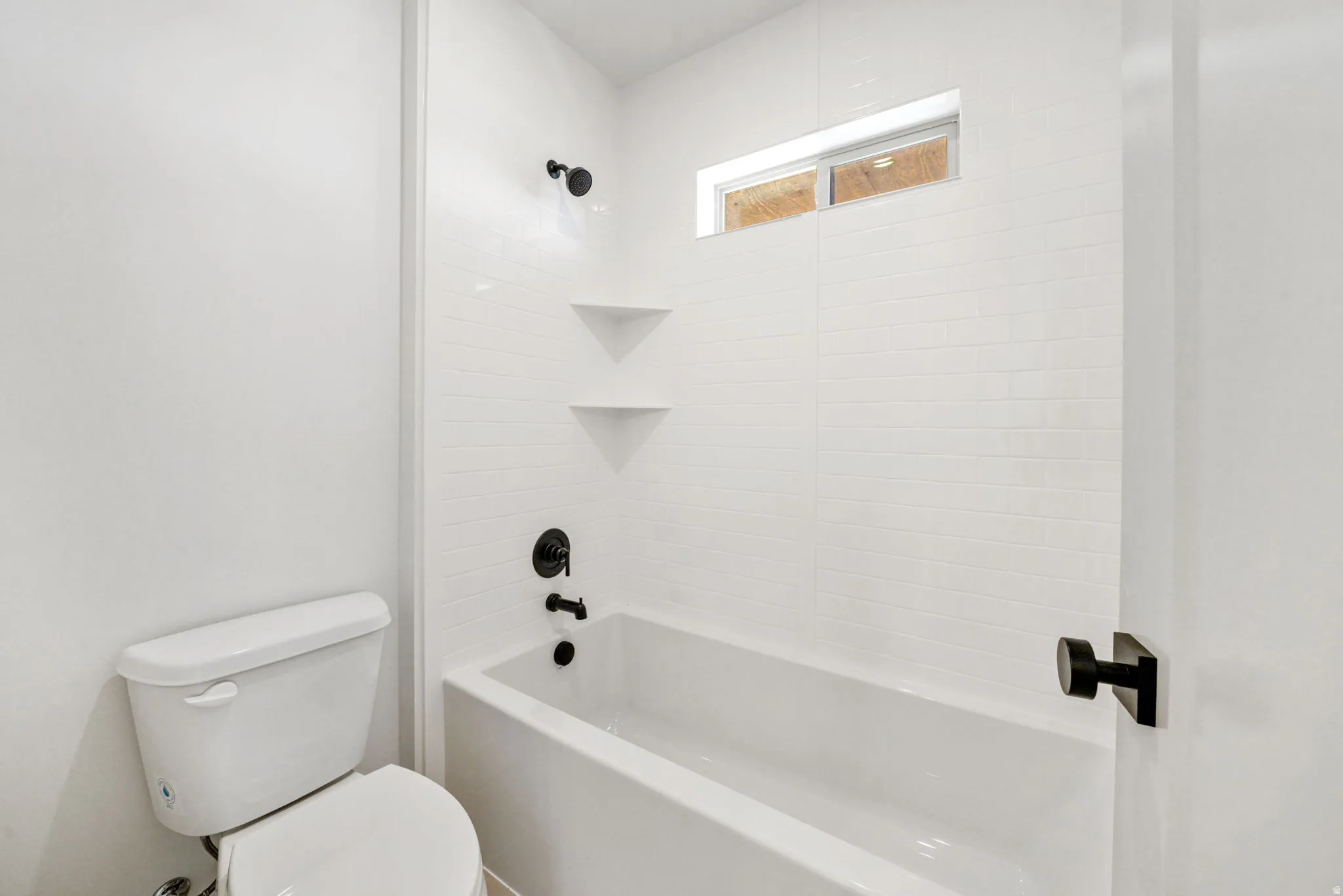 Bathroom featuring shower / bath combination and toilet