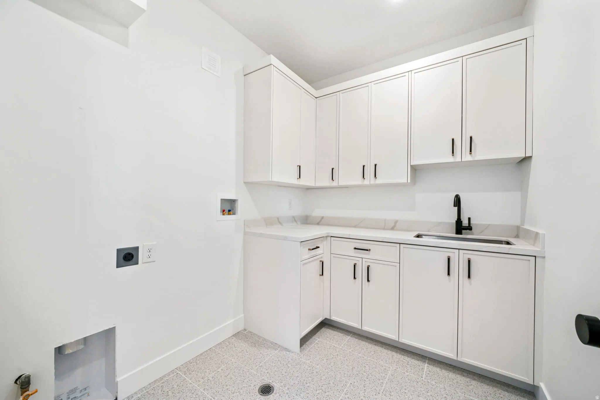 Laundry room with hookup for a washing machine, cabinet space, and hookup for an electric dryer