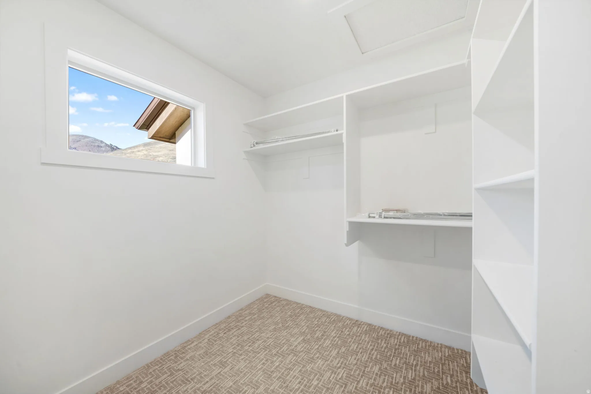 Walk in closet featuring attic access