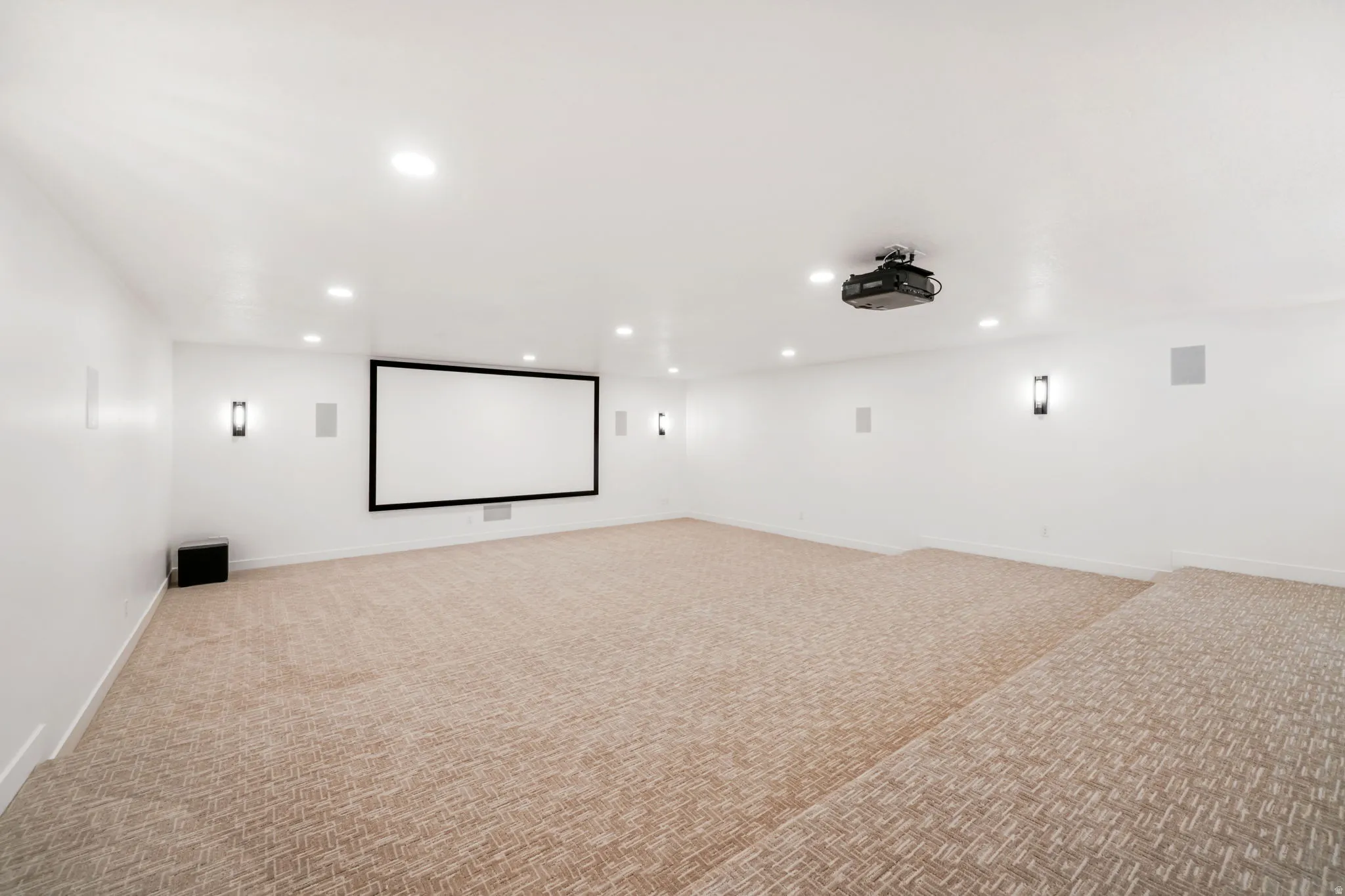 Cinema room featuring light colored carpet and recessed lighting
