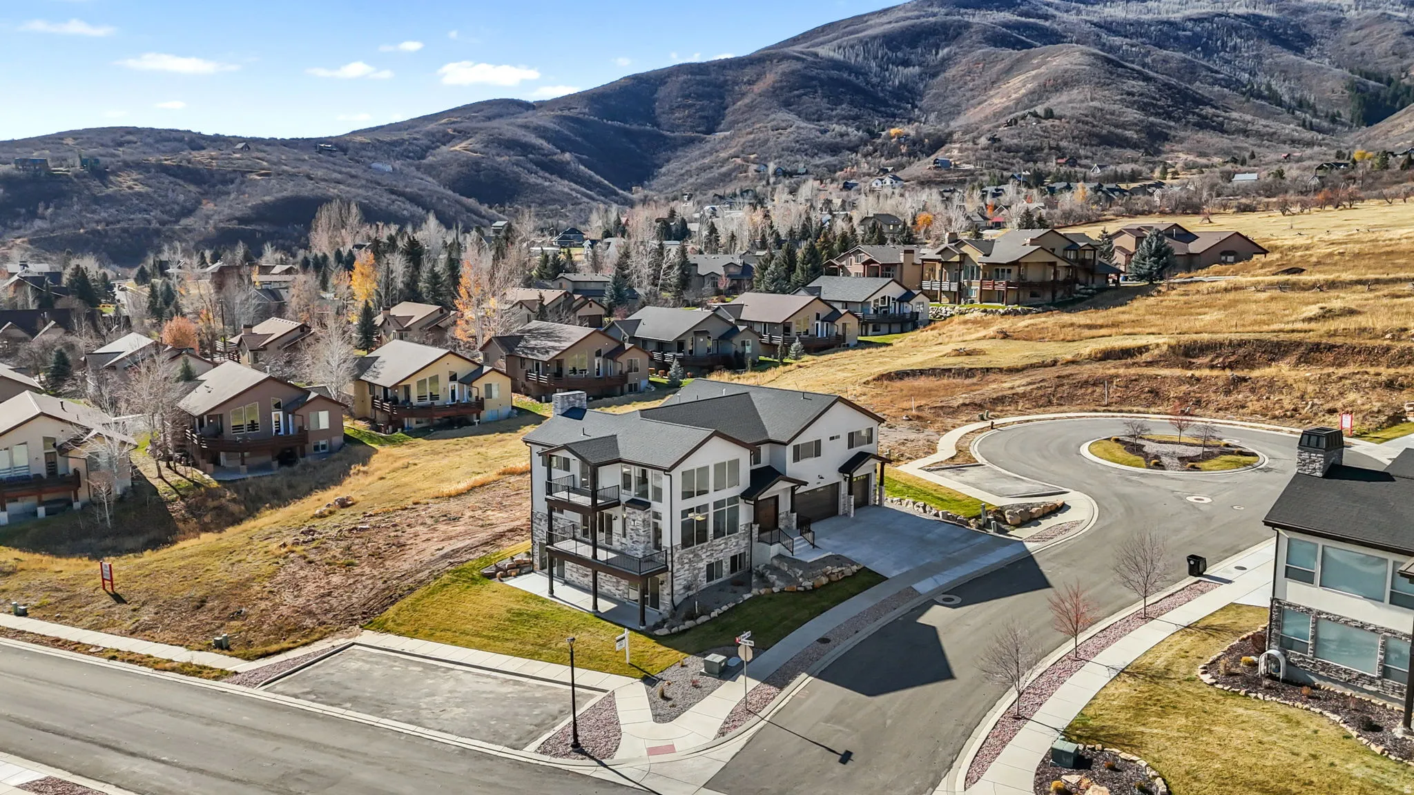 Aerial perspective of suburban area with a mountainous background