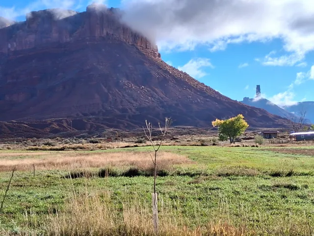 View of mountain backdrop with rural landscape