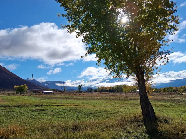 View of green lawn featuring a rural view and a mountain view