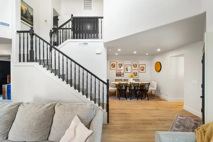 Stairway featuring wood finished floors, recessed lighting, and a towering ceiling