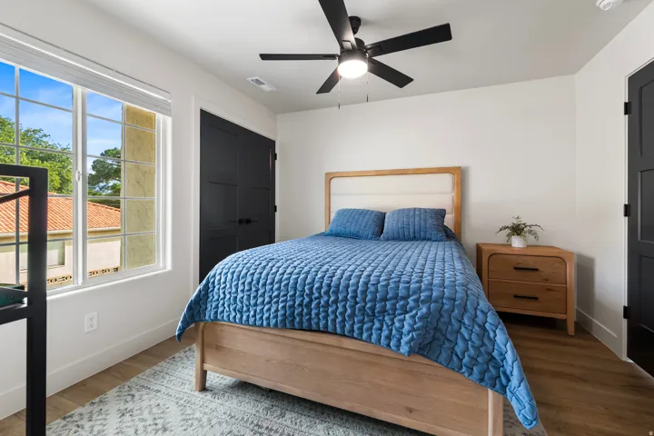 Bedroom with wood finished floors and a ceiling fan