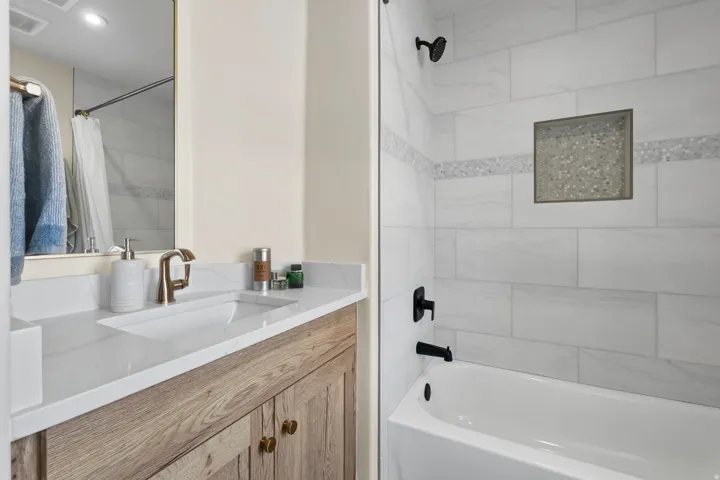 Full bathroom featuring vanity and shower / bath combination with curtain