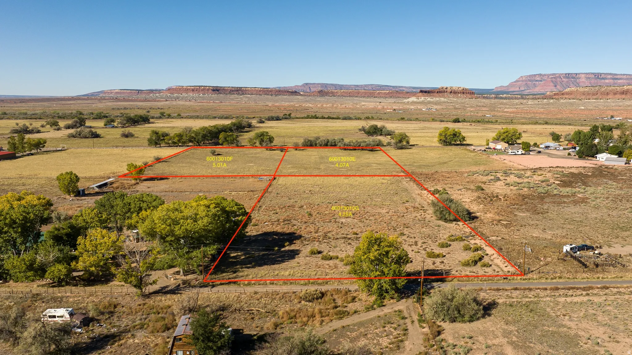 Adjacent land available for purchase Aerial view of sparsely populated area featuring property boundaries highlighted and mountains