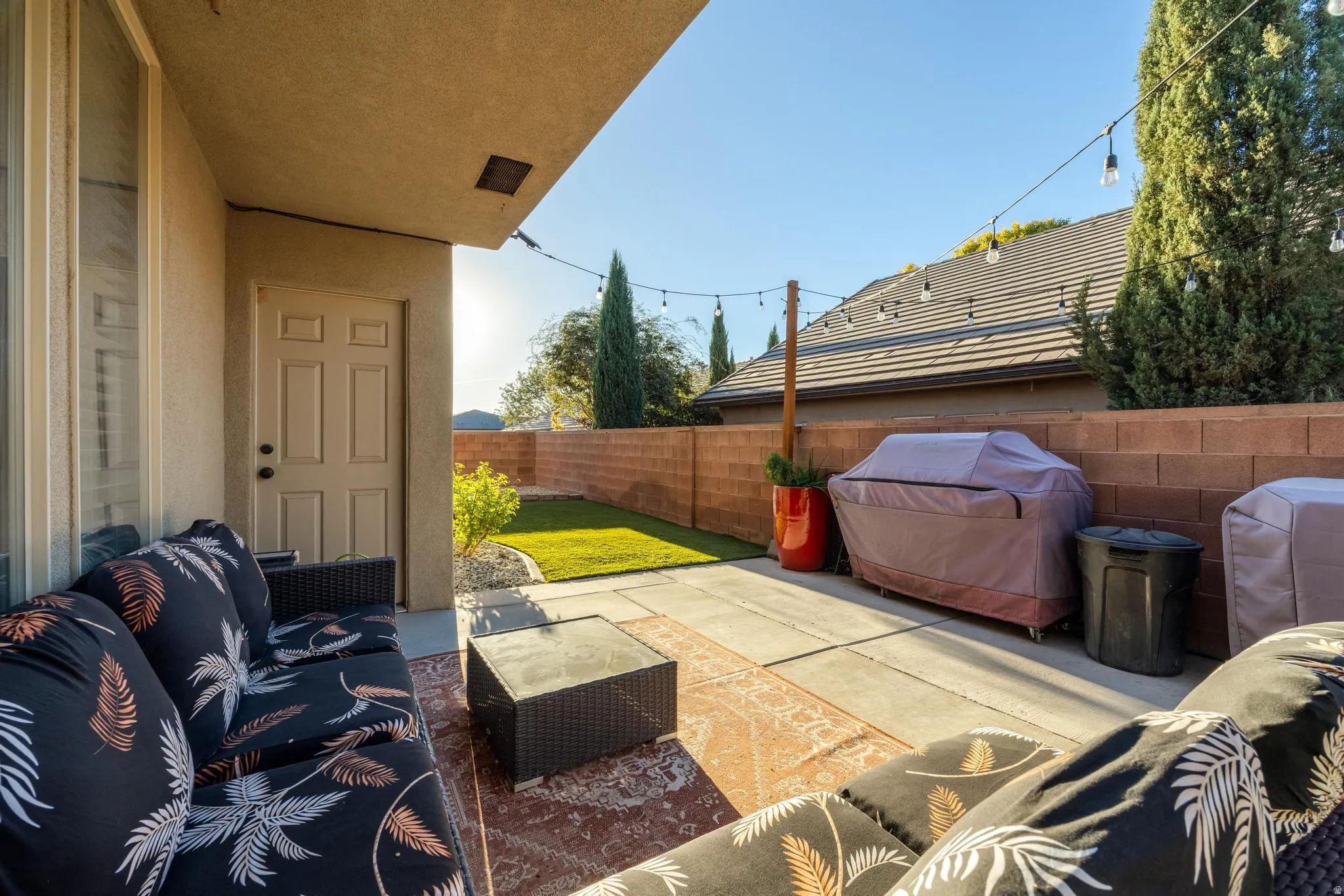 Fenced backyard with a patio area