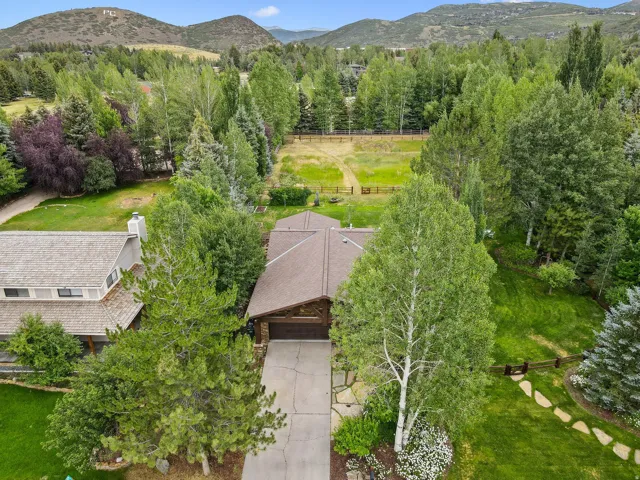 Aerial view of property and surrounding area with a mountainous background