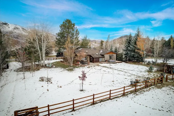 Snowy yard featuring a patio area and a mountain view