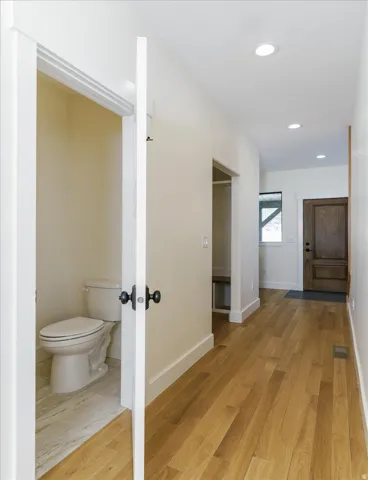 Hall featuring light wood-style floors and recessed lighting