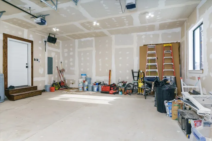 Garage with a garage door opener and electric panel