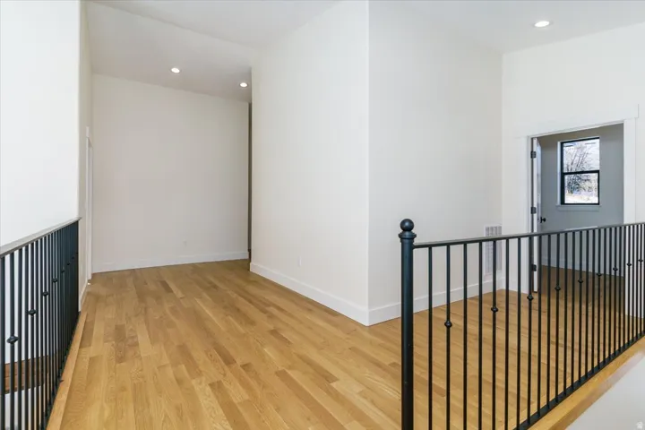 Corridor featuring recessed lighting, light wood finished floors, and an upstairs landing