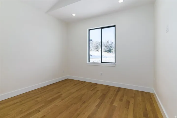Spare room with light wood finished floors and recessed lighting