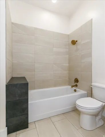 Bathroom featuring bathtub / shower combination and tile patterned flooring