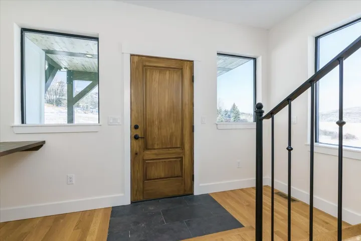 Foyer featuring wood finished floors and stairway