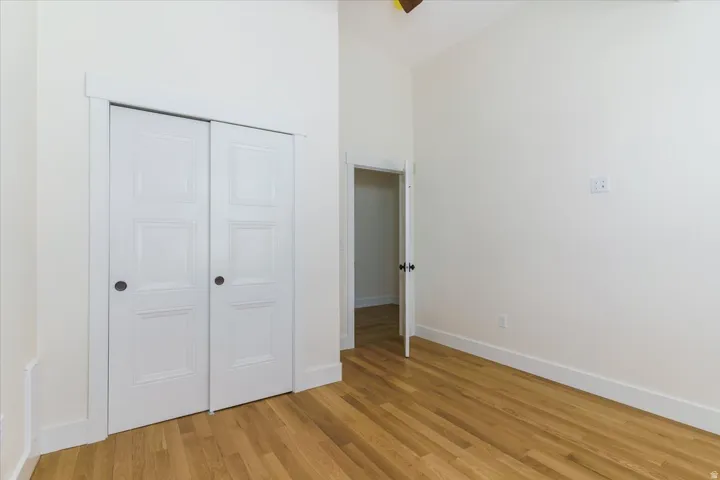Unfurnished bedroom with light wood-type flooring and a closet