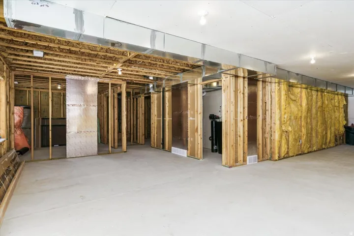 Unfinished basement featuring a water softener