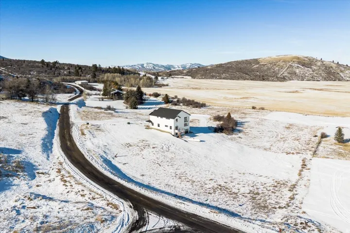 Snowy aerial view featuring a mountain view