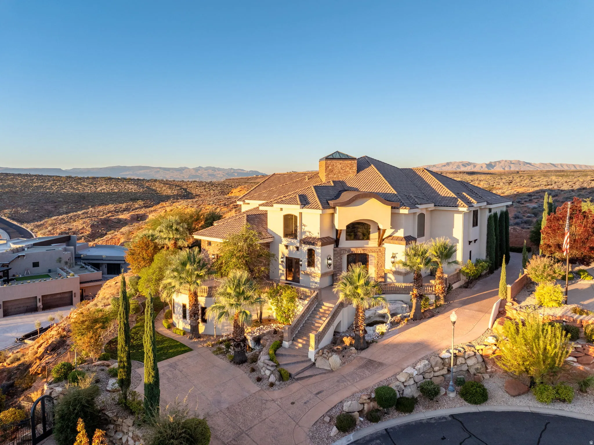 Mediterranean / spanish-style home with stucco siding, a chimney, a mountain view, and stairway