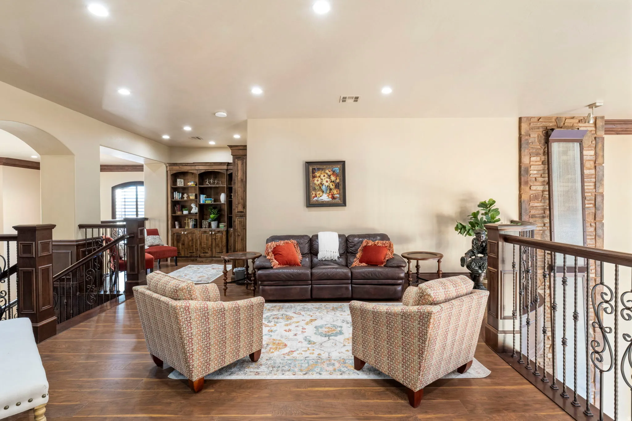 Living area featuring dark wood finished floors, recessed lighting, and arched walkways