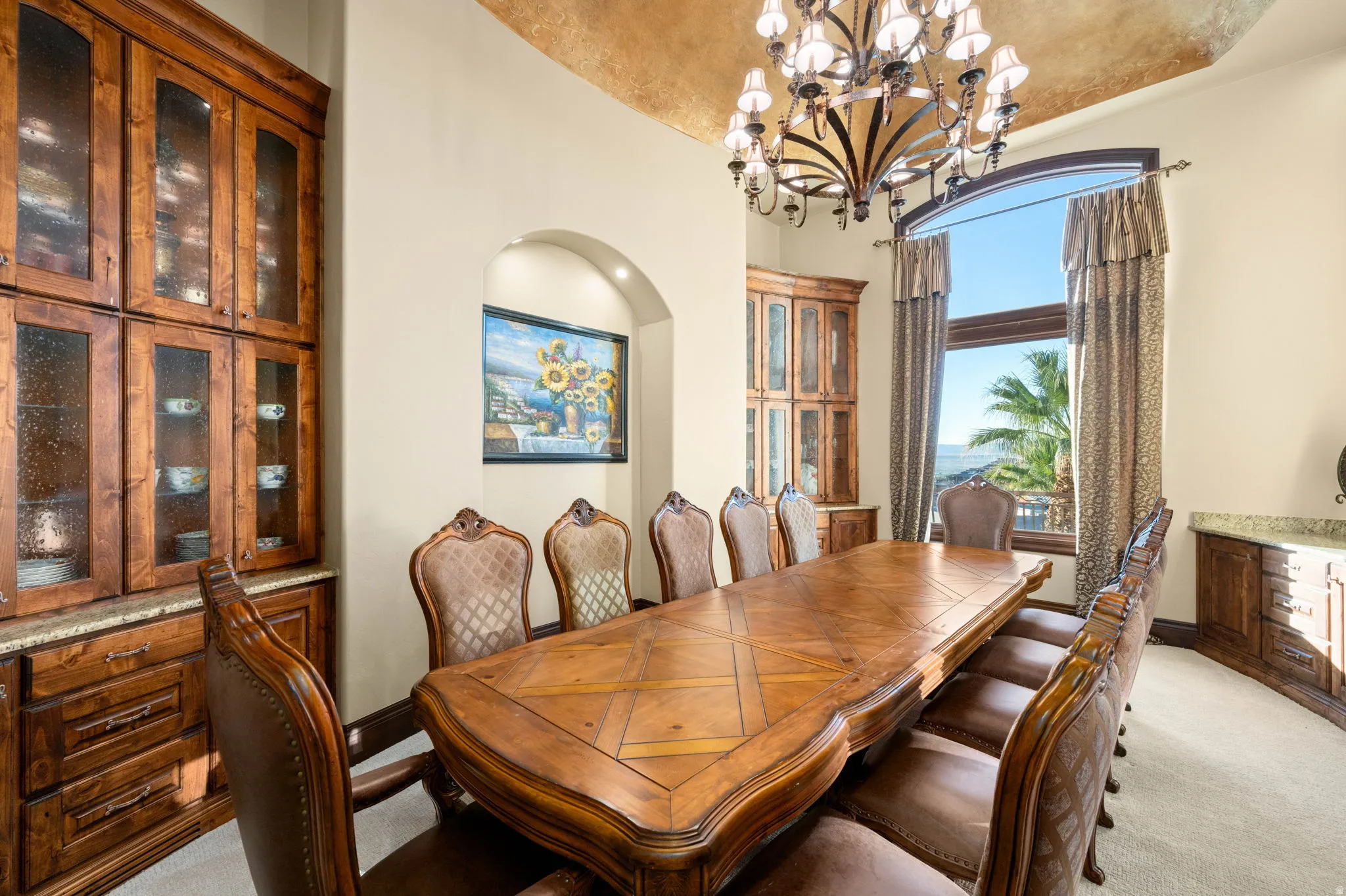 Dining area with light carpet, a chandelier, and vaulted ceiling