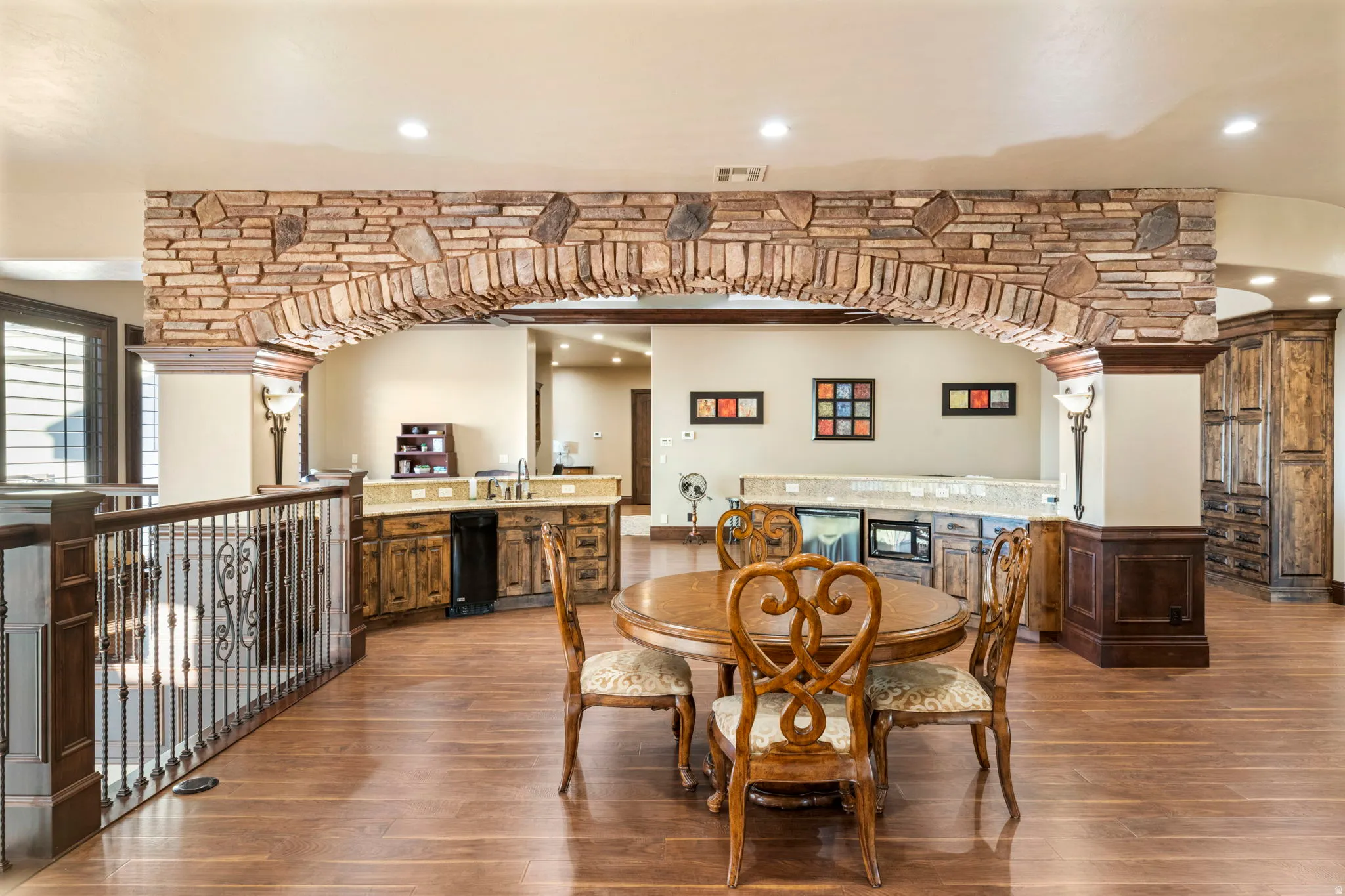 Dining room featuring bar with sink, recessed lighting, and wood finished floors