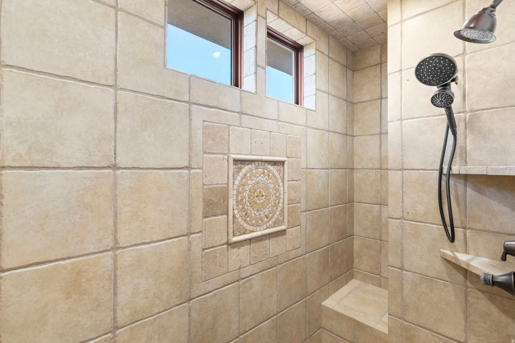 Full bath featuring a tile shower
