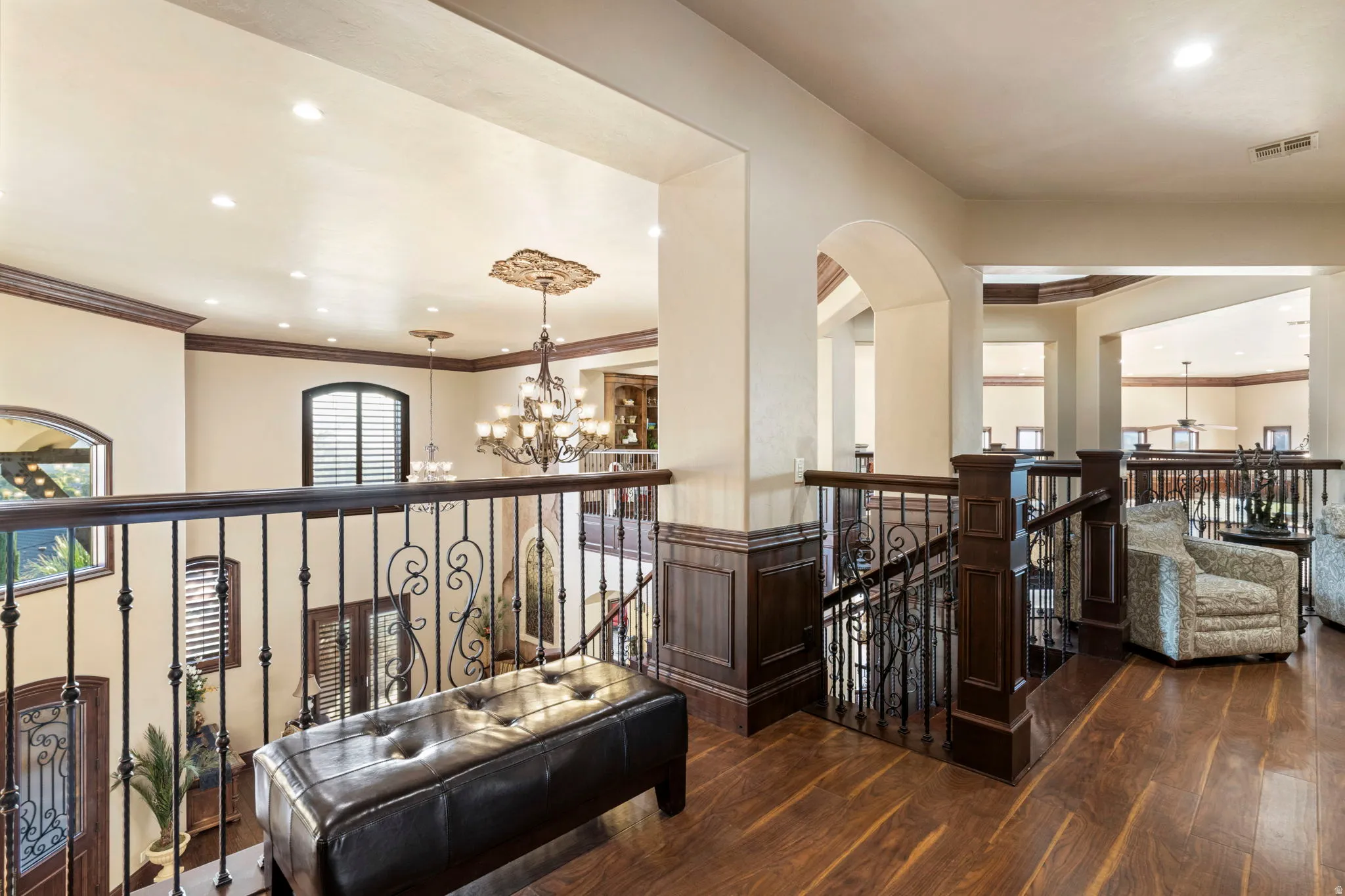 Hallway featuring a chandelier, an upstairs landing, dark wood-style flooring, recessed lighting, and ornamental molding