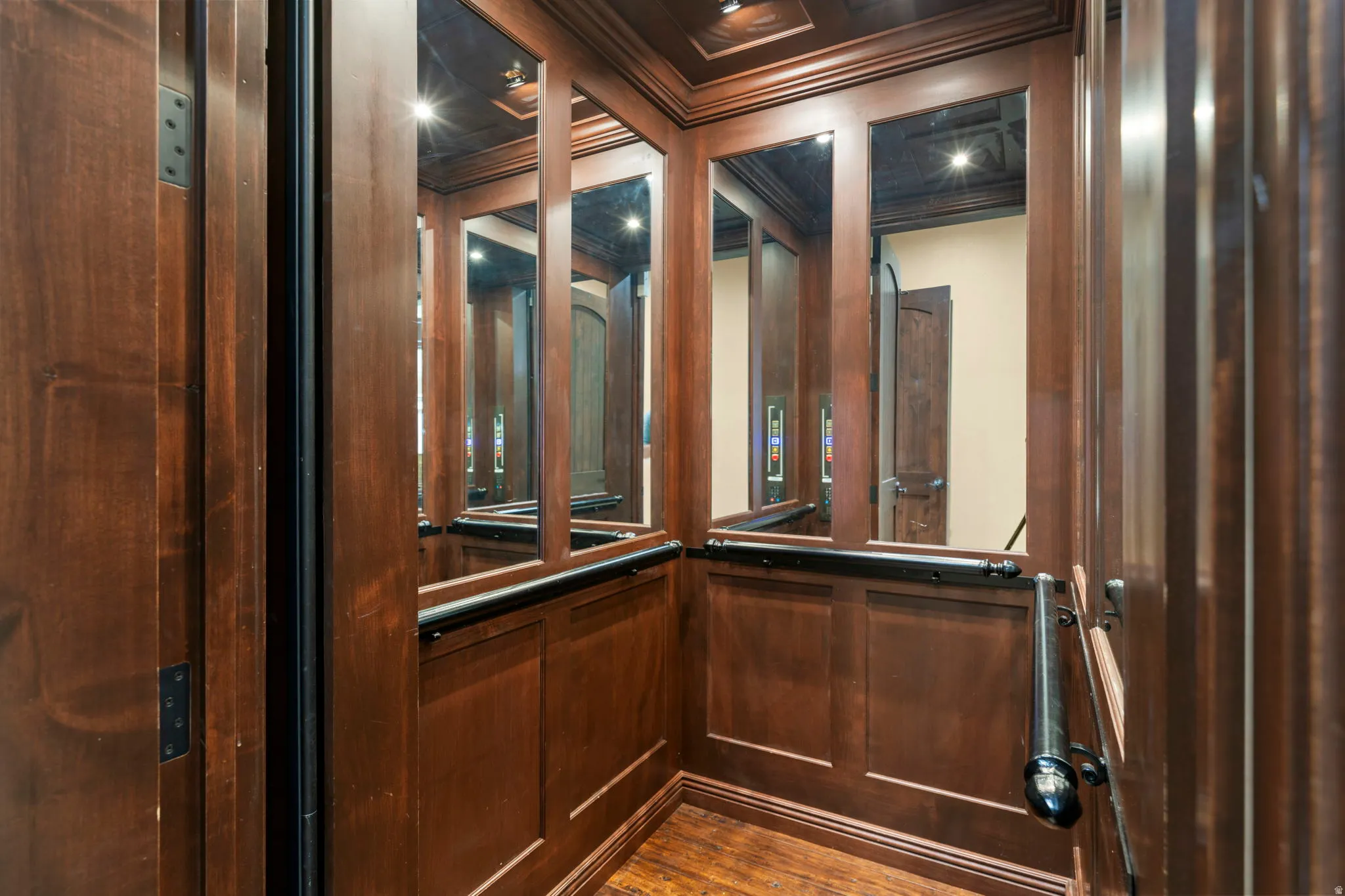 Elevator featuring crown molding and wood finished floors