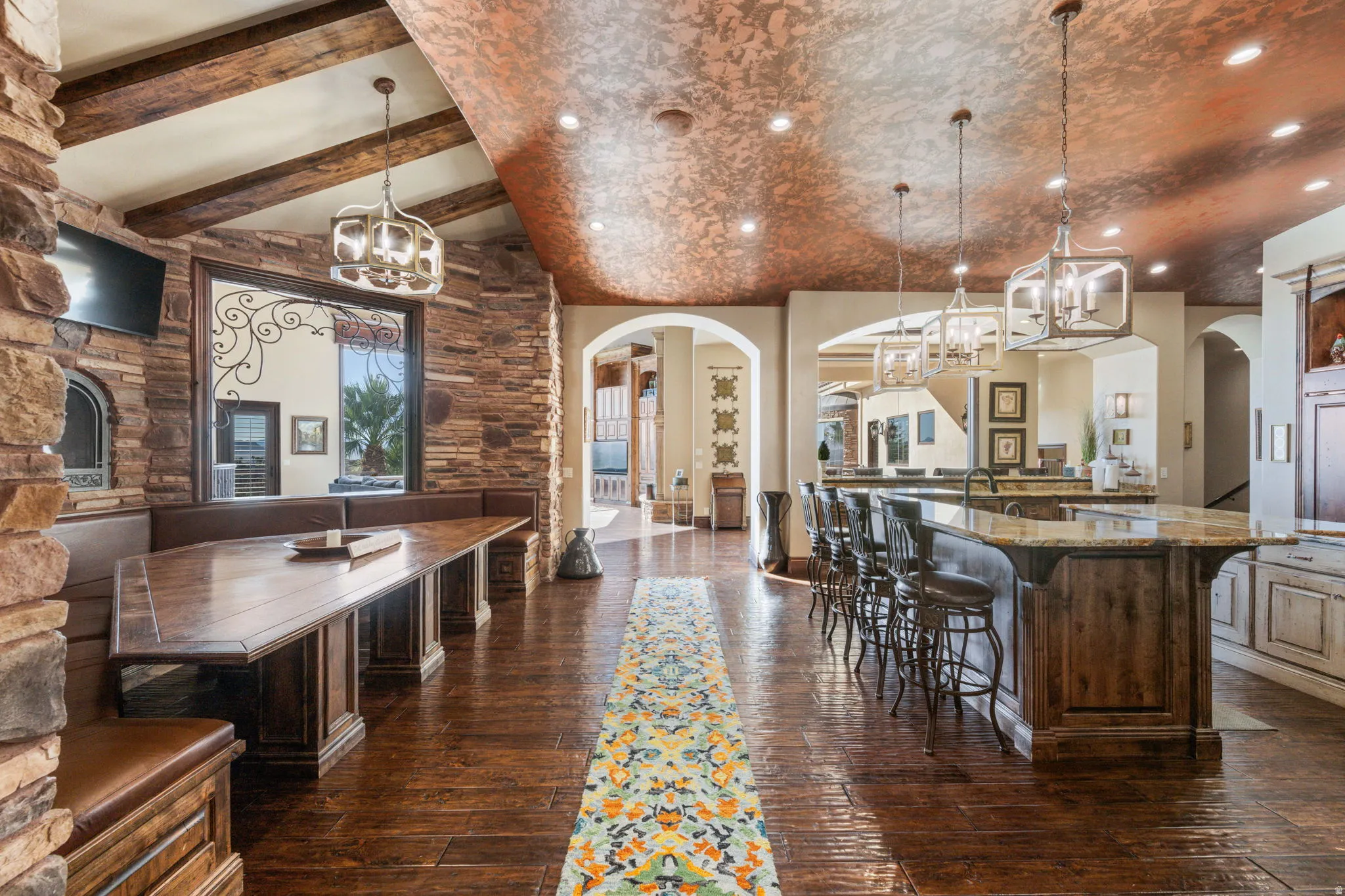 Kitchen featuring a chandelier, arched walkways, a breakfast bar, and recessed lighting