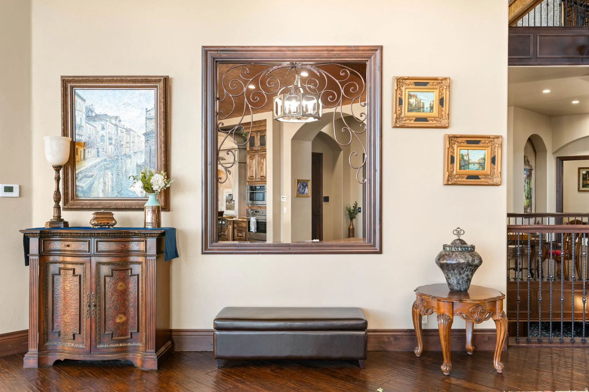 Hallway featuring hardwood / wood-style floors, arched walkways, and a chandelier