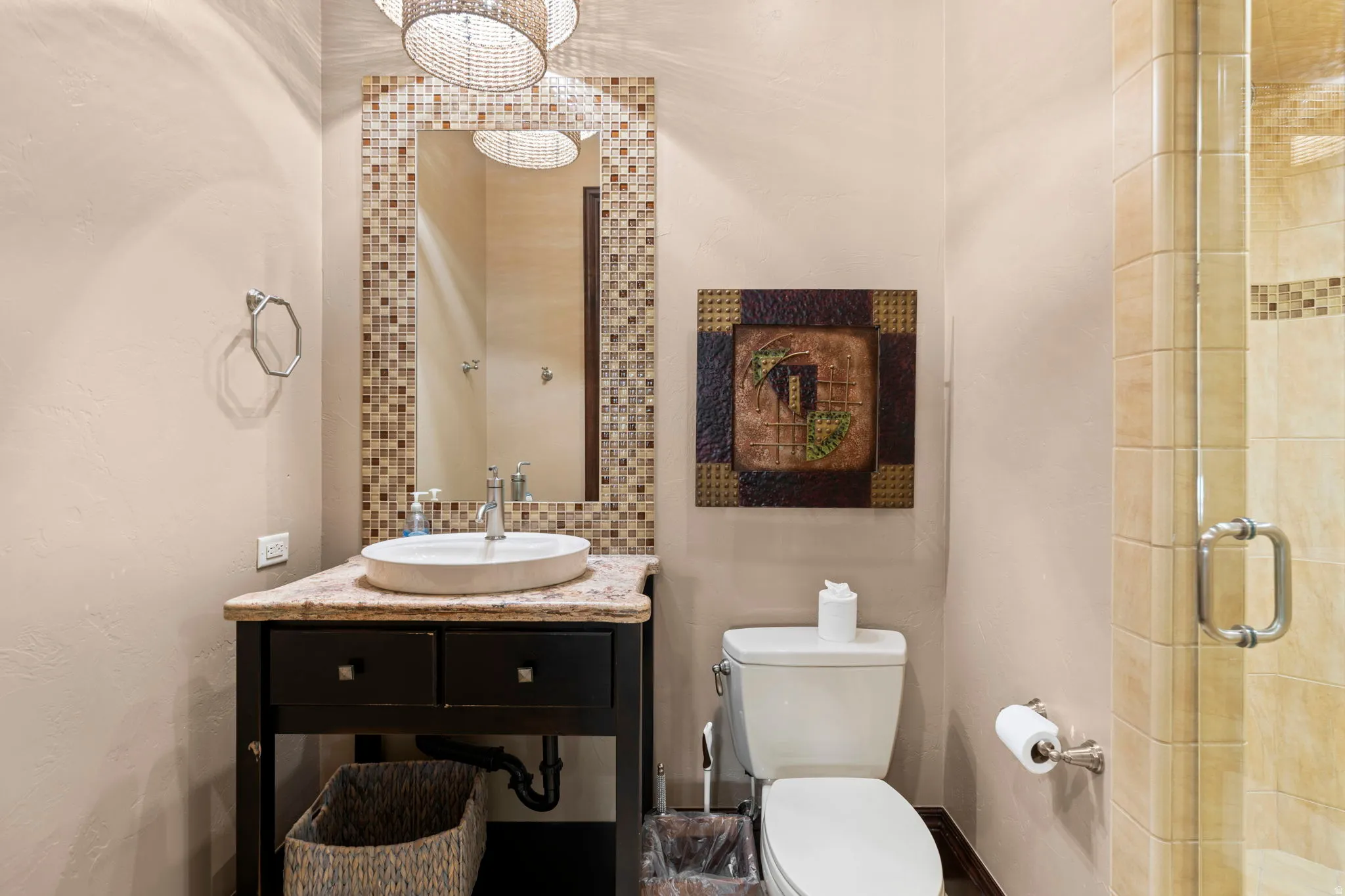 Bathroom featuring vanity, a textured wall, and a tile shower
