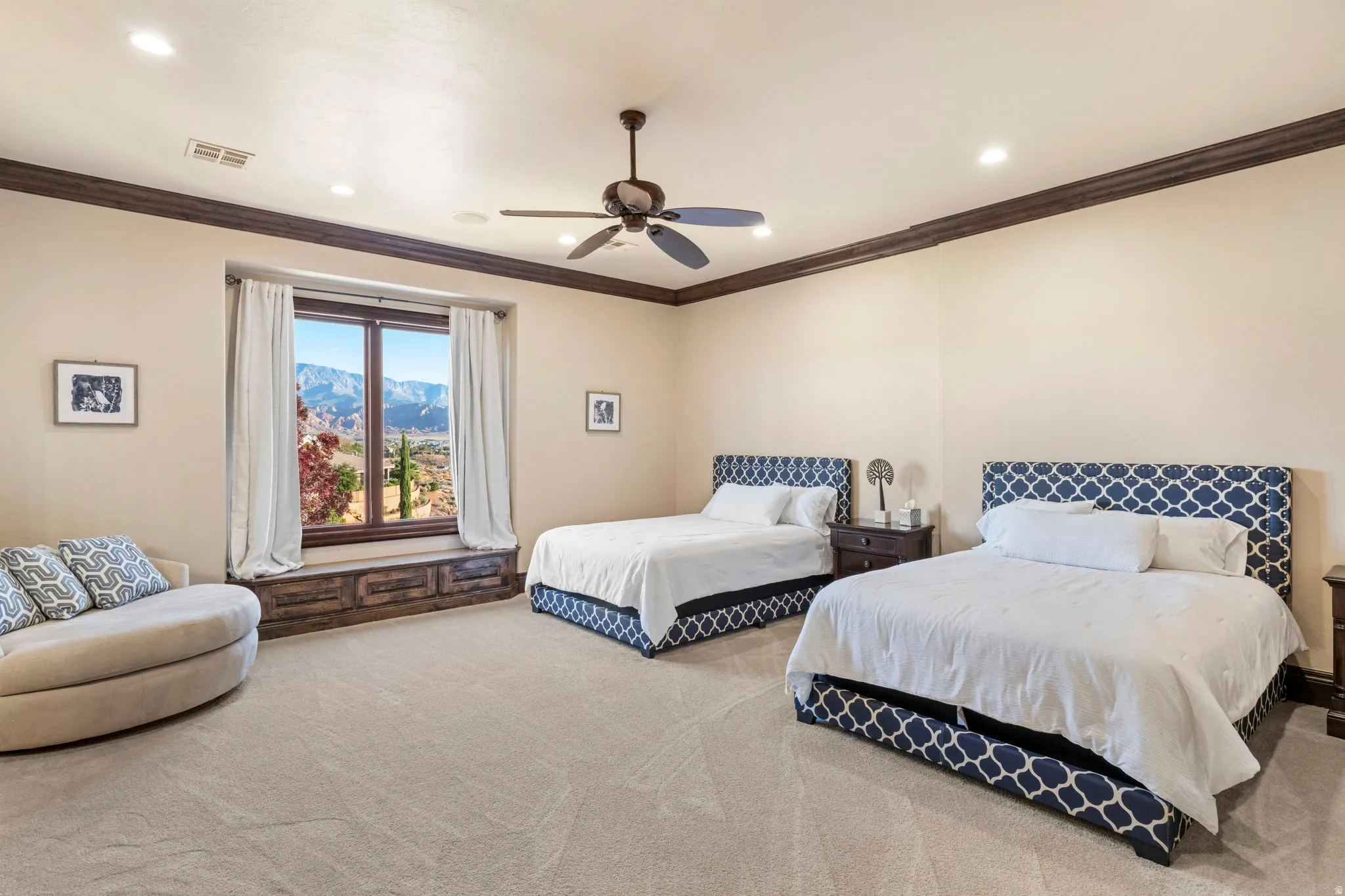 Bedroom with crown molding, carpet flooring, a ceiling fan, a mountain view, and recessed lighting