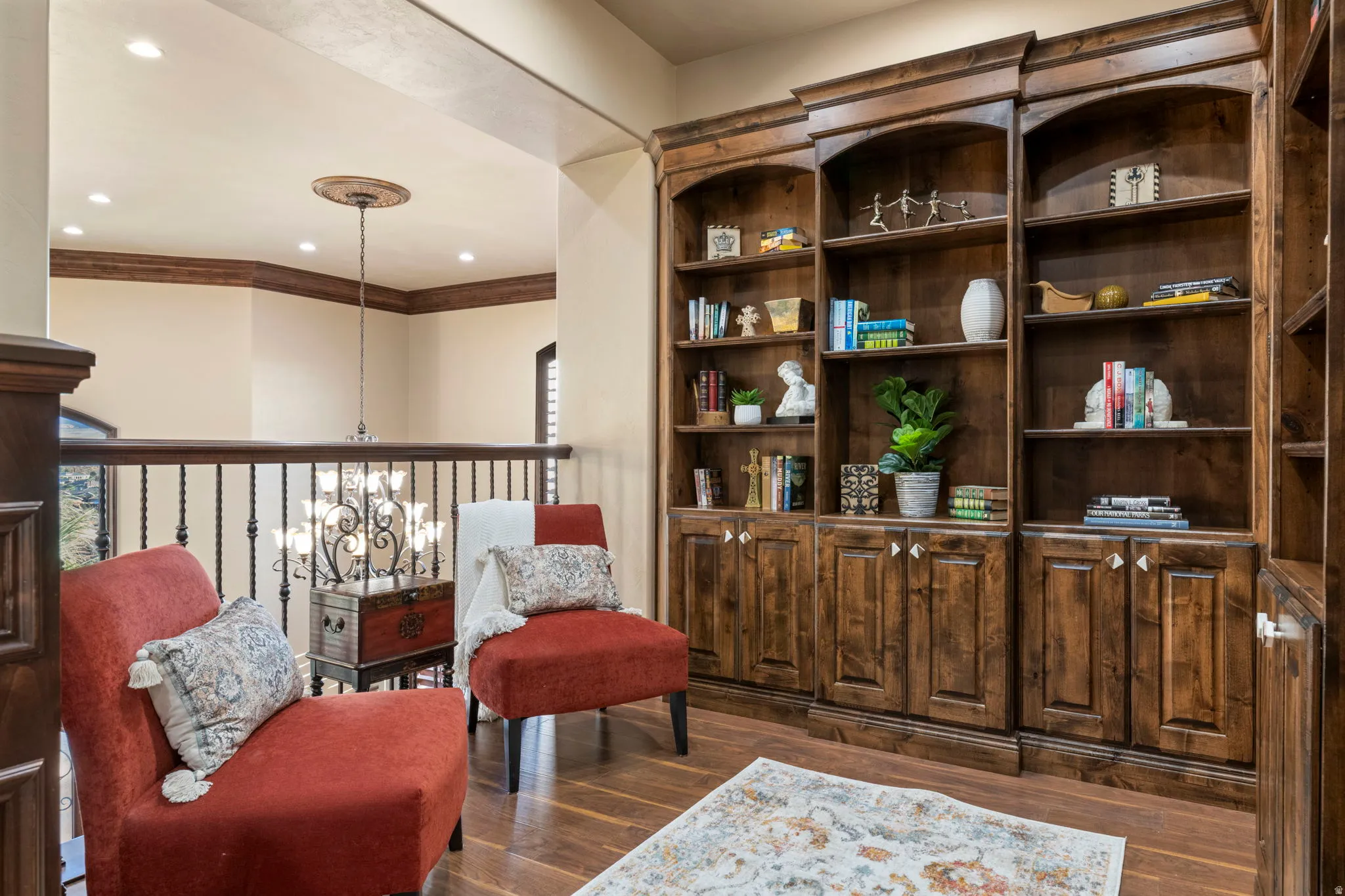 Living area featuring dark wood-style flooring, recessed lighting, and a chandelier