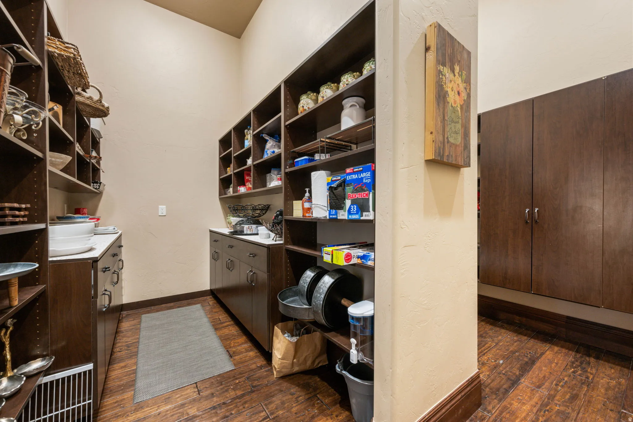 Office featuring dark wood-style flooring and a textured wall