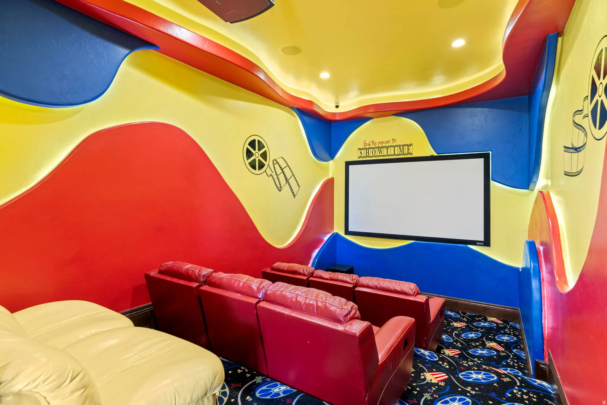 Cinema featuring a raised ceiling and recessed lighting